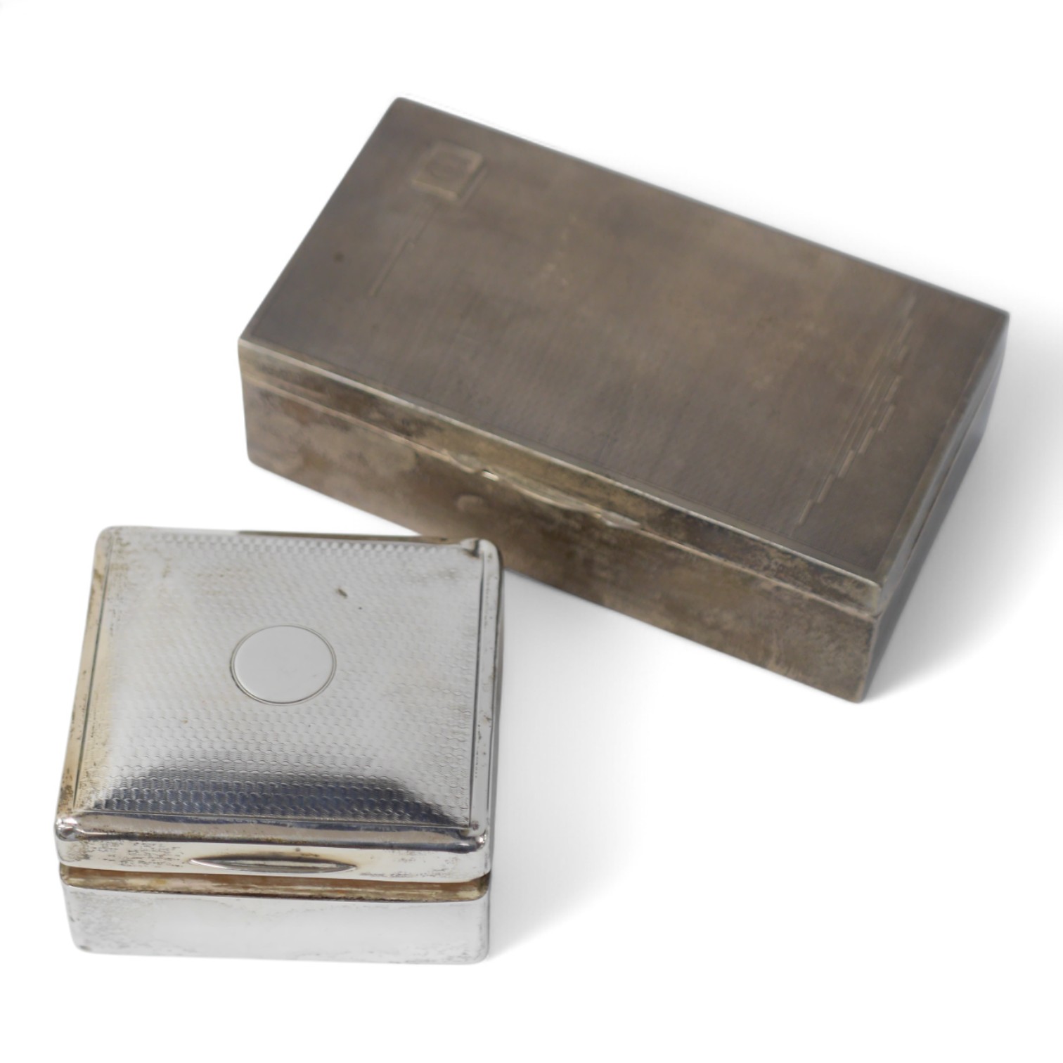 An Art Deco silver mounted rectangular cigarette box, with engraved inscription, Birmingham, 1935, 16.8cm and one other smaller silver mounted cigarette case, London, 1921. Condition - poor to fair